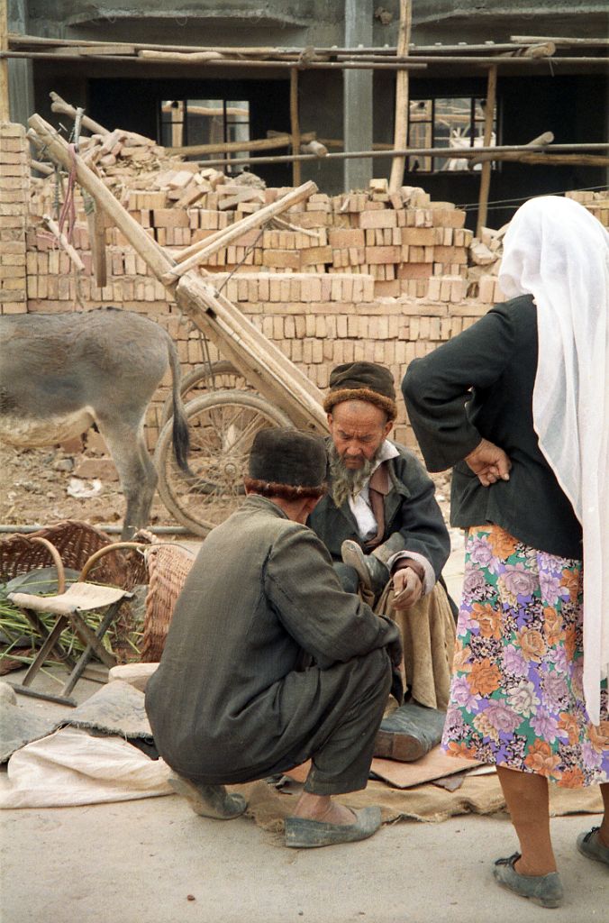 44 Kashgar Sunday Market 1993 Man Repairing Shoes